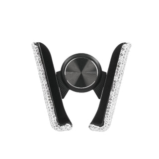 The Bling Hands-Free Car Vent Mount by Gabba Goods features a stylish black and silver design adorned with sparkling rhinestones. Shaped like an open "V" with rhinestone-lined edges, it also includes a black circular grip in the center with a textured surface, ensuring hands-free operation.