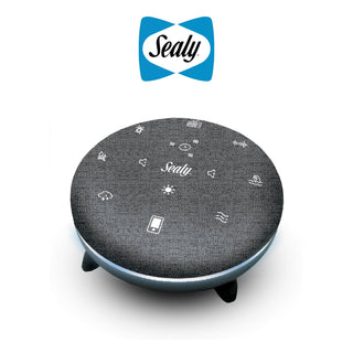 A round, black smart home hub with the Sealy logo in the center and various icons indicating different functions around it. The Sealy logo is also displayed above the device.