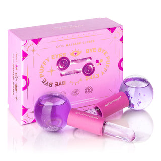 Pink and purple Cryo Facial Treatment Massage Globes by Almost Famous, designed to reduce puffiness, are placed in front of their matching pink and purple box. The box features the text "Cryo Massage Globes," "Bye Bye Puffy Eyes," and whimsical eye-related graphics, adding a refreshing touch to your skincare routine.