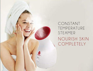 A woman with a towel wrapped around her hair is using the Pursonic Pore Purifying Facial Steamer. She is smiling and touching her face. Next to her, there's text that reads "Pore Purifying Facial Steamer: Nourish Skin Completely." The steamer is emitting visible steam, offering a moisturizing spa experience while tackling blackheads.