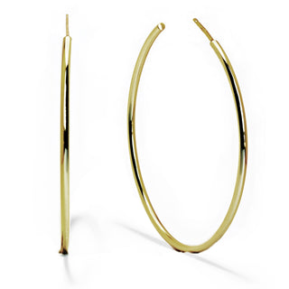 A pair of large, thin gold hoop earrings made from quality materials by Sonia Hou Jewelry. One Perfect Hoop Earring is positioned upright, showcasing its circular shape, while the other is laid flat to display its width. The polished surface reflects light, highlighting their smooth and shiny texture—ideal hoop earrings for everyday wear.